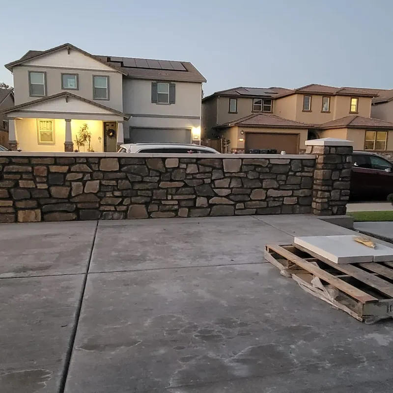 Block retaining wall running the length of a Sacramento driveway