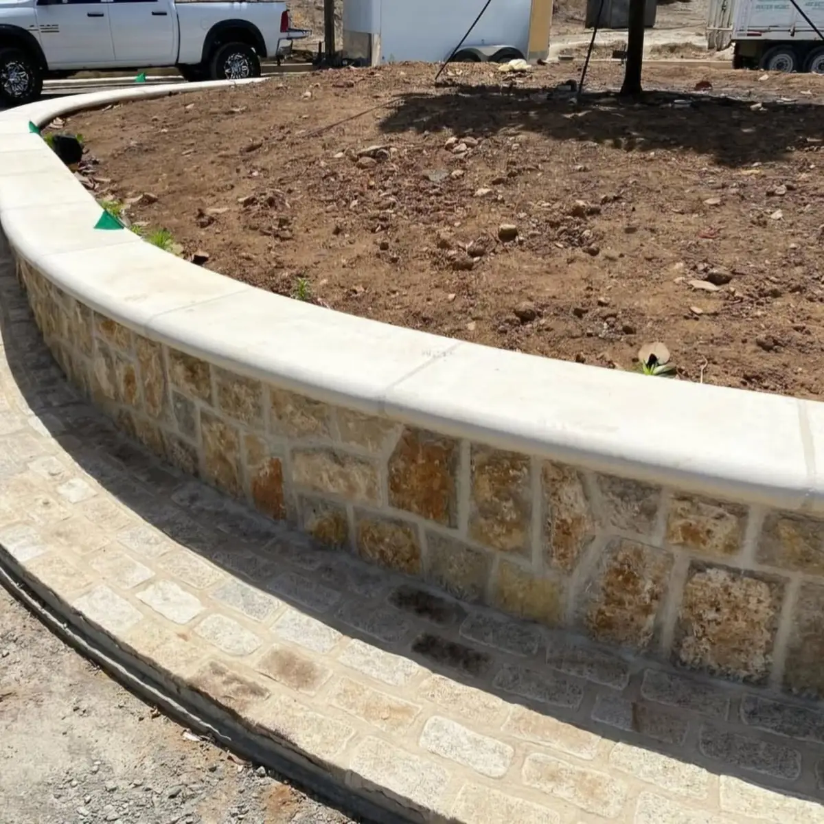 Curved stone planter wall with a smooth cast cap, Sacramento