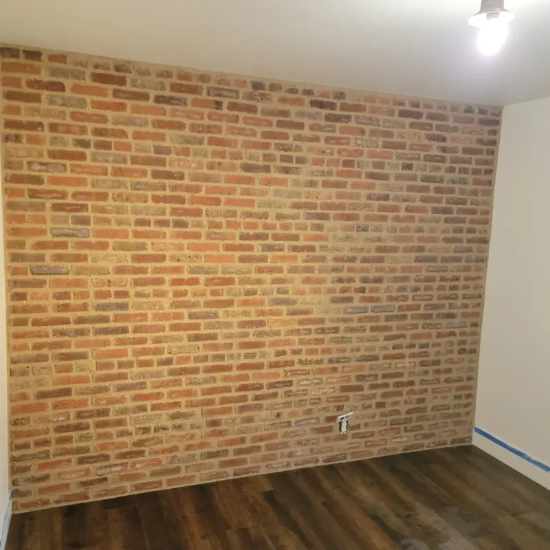 Interior brick accent wall laid to line in a Sacramento home