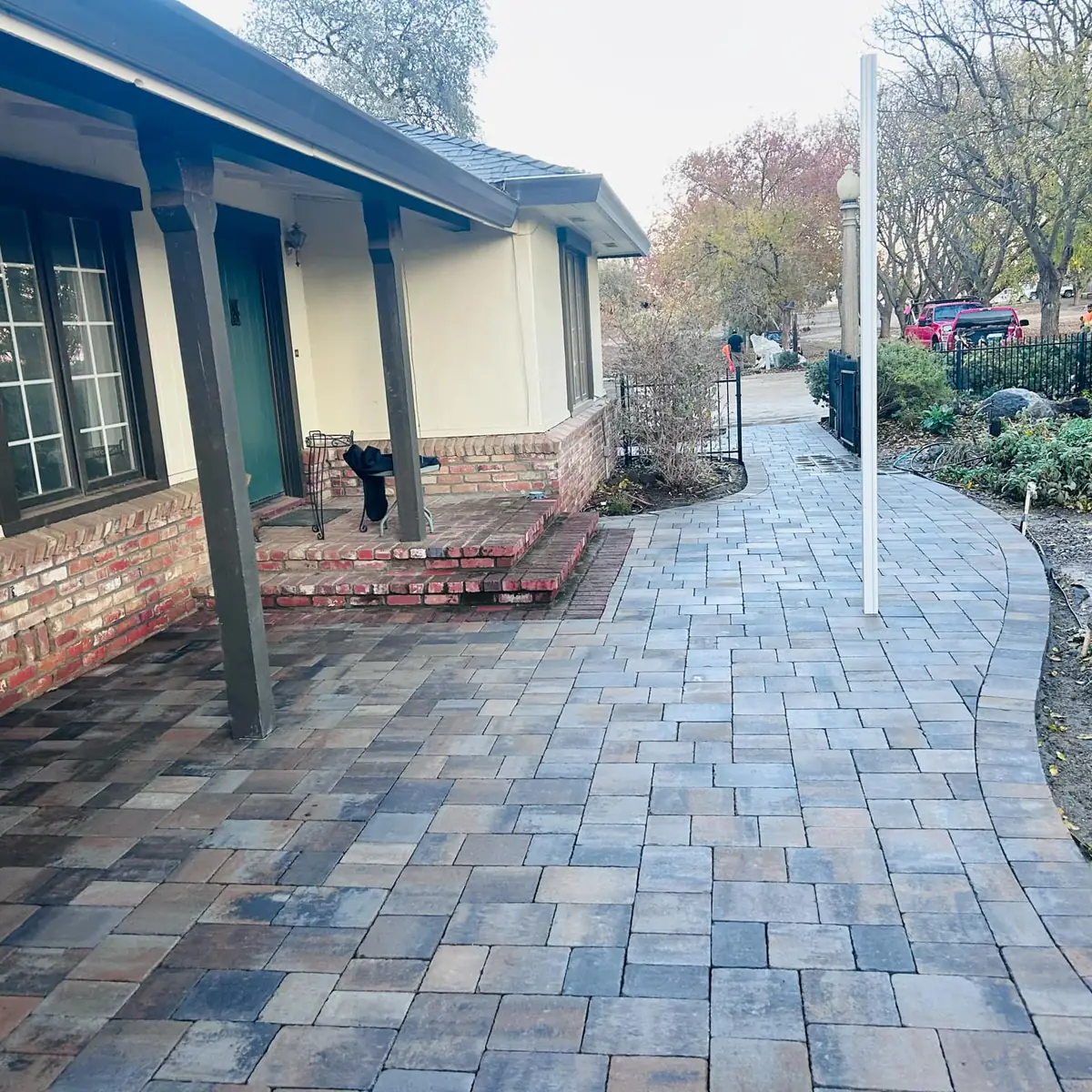 Curved paver walkway leading to brick porch steps in Sacramento