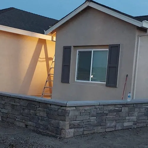 Stone veneer wainscot running along the front of a Sacramento house