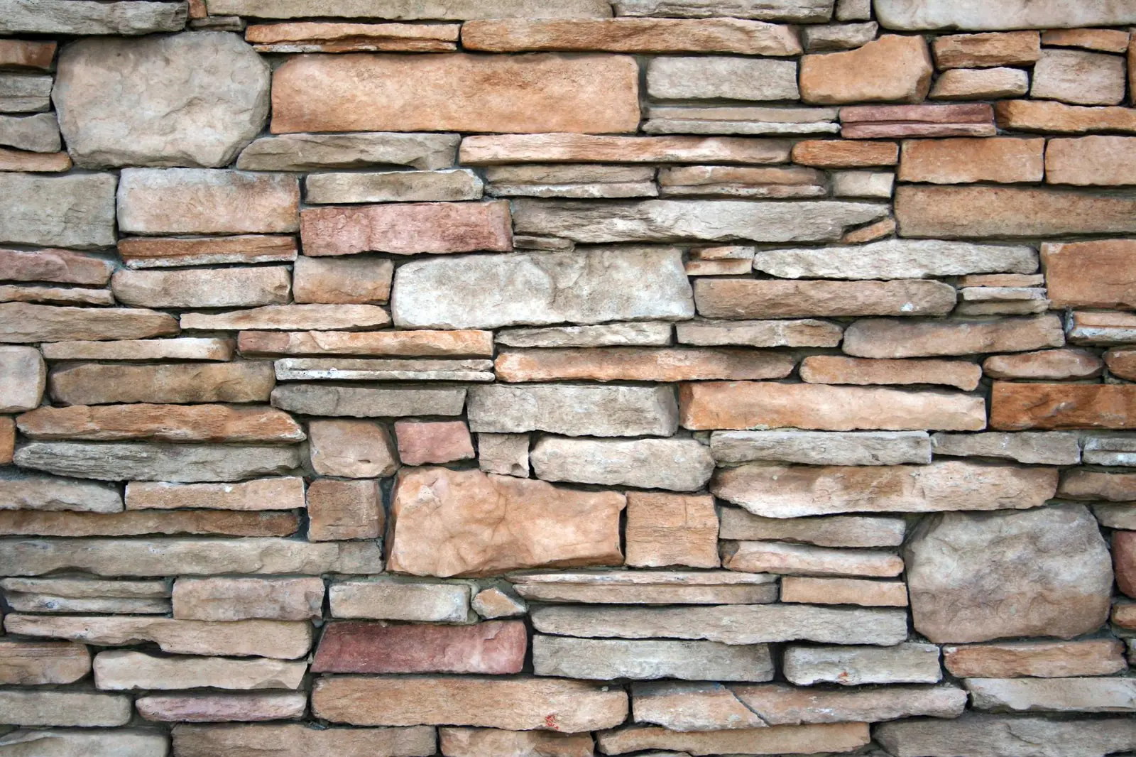 Stacked stone veneer fitted across the face of a wall