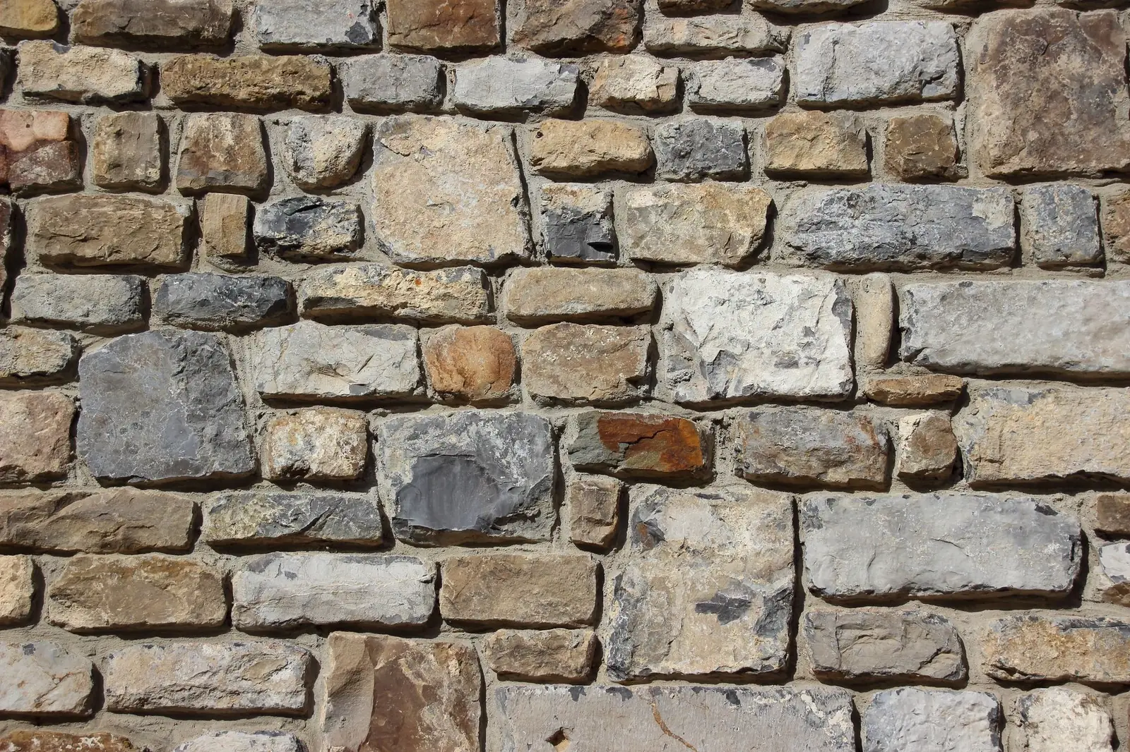 A dry laid stone garden wall, coursed and level
